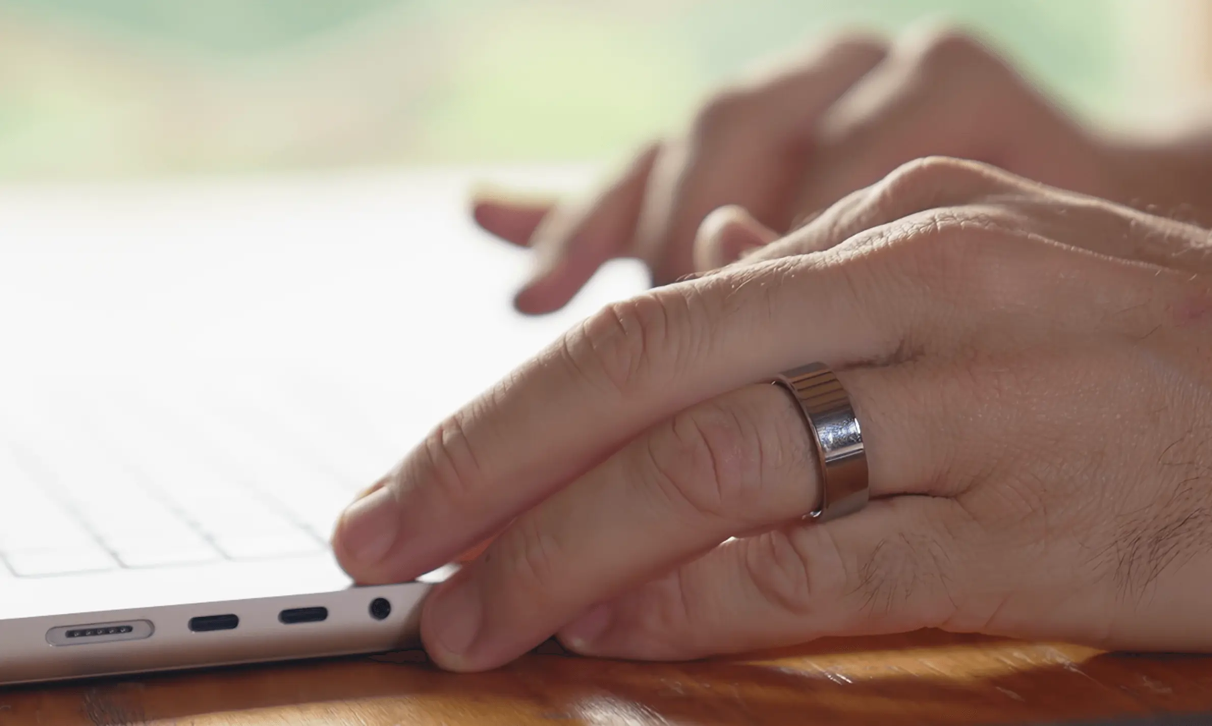 man typing on computer wearing smart ring